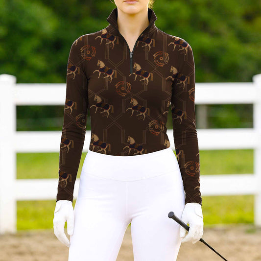 Woman wearing RIDER ATELIER heritage monogram horse espresso brown equestrian quarter-zip top at the outdoor pasture