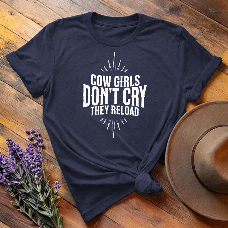 Navy blue "Cow Girls Don't Cry They Reload" western equestrian t-shirt, flat lay on wooden background