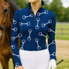 Woman standing with chestnut horse wearing navy equestrian white snaffle bit allover print quarter-zip riding top