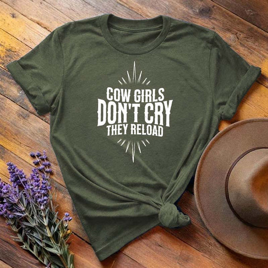 Olive green "Cow Girls Don't Cry They Reload" western equestrian t-shirt, flat lay on wooden background