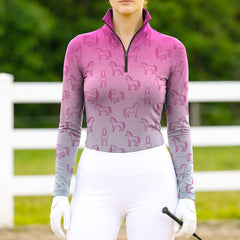 Woman wearing RIDER ATELIER ombre line art horse magenta-gray equestrian quarter-zip top at the outdoor pasture
