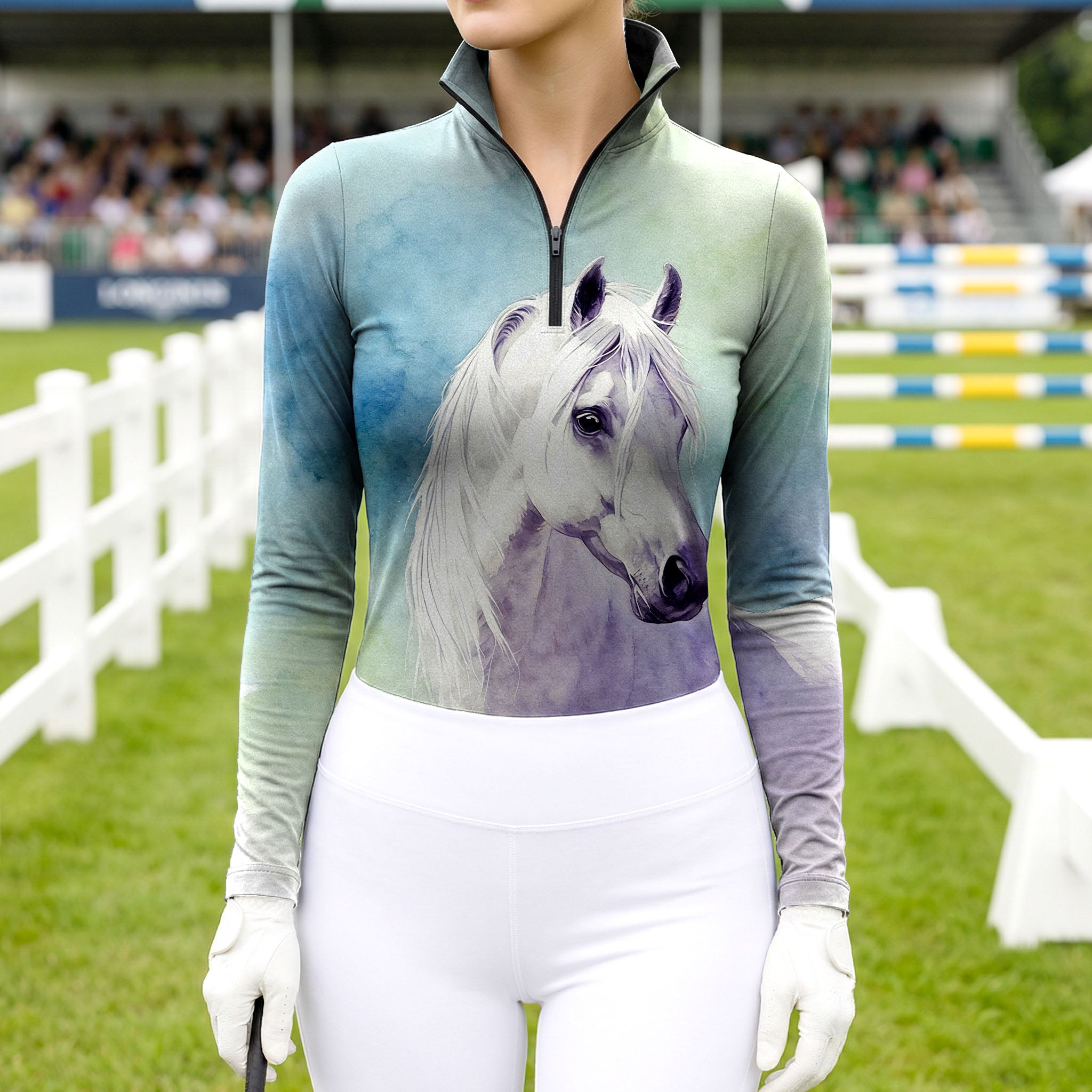 Woman wearing RIDER ATELIER watercolor white horse ombre teal-purple equestrian quarter-zip top at the show jumping arena