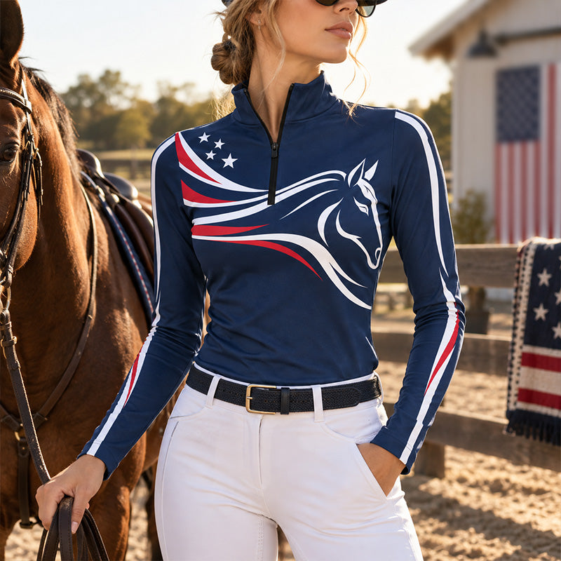 Close view of white horse print and red and white star accents on navy riding top