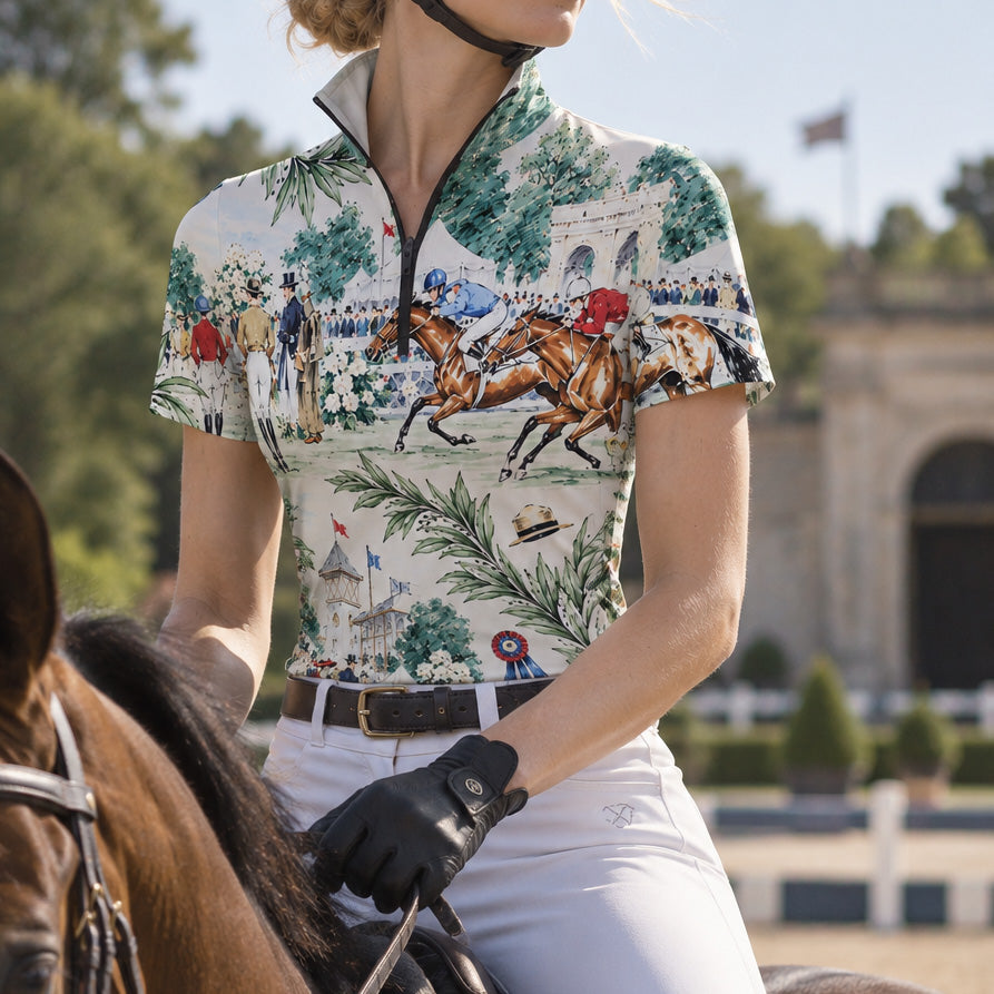 Close up of a rider wearing the top while mounted on a horse in an outdoor arena