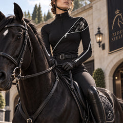 Rider seated on a black horse outside the stable wearing the riding top